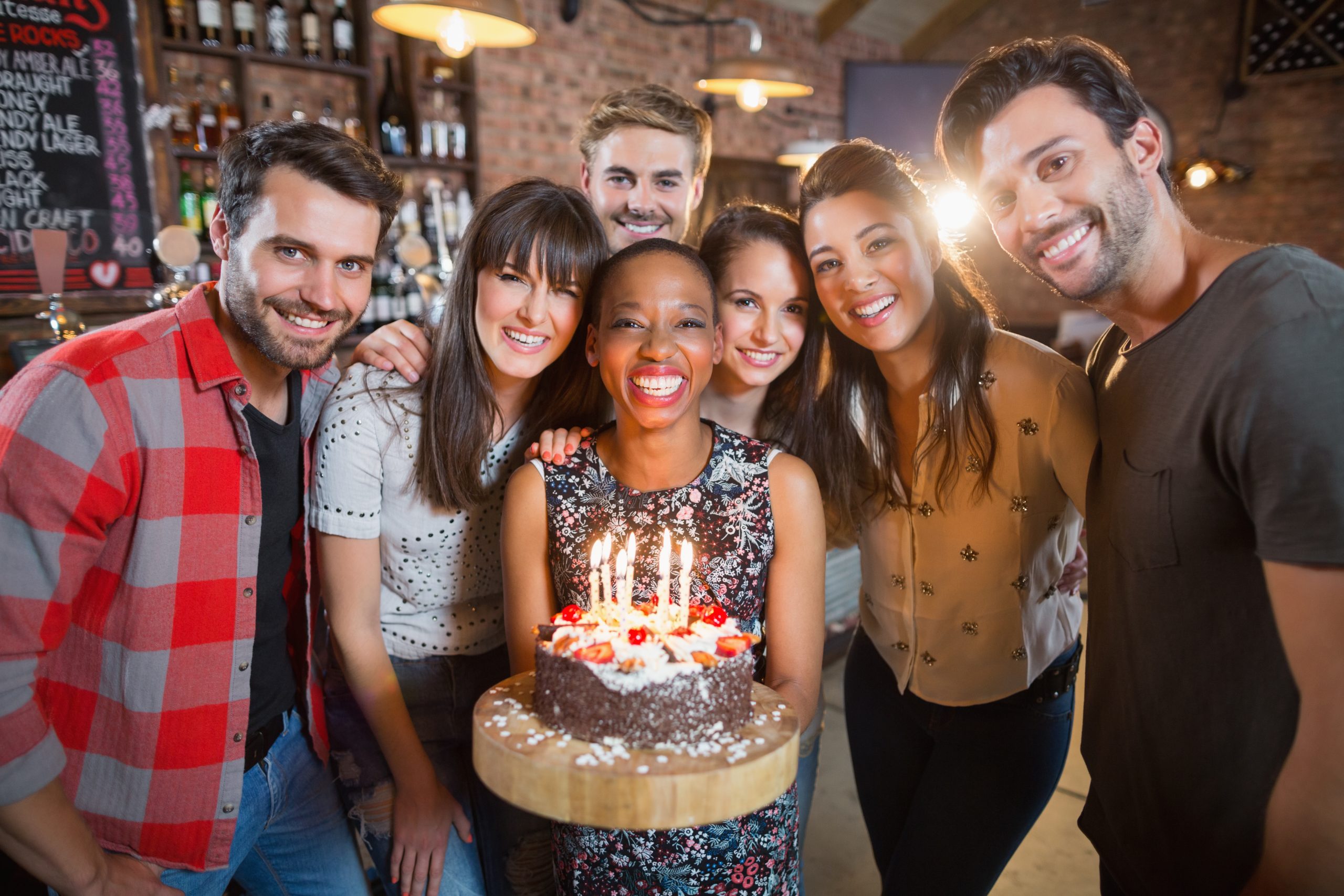 portrait-of-happy-friends-holding-birthday-cake-in-2025-10-28-21-50-55-utc